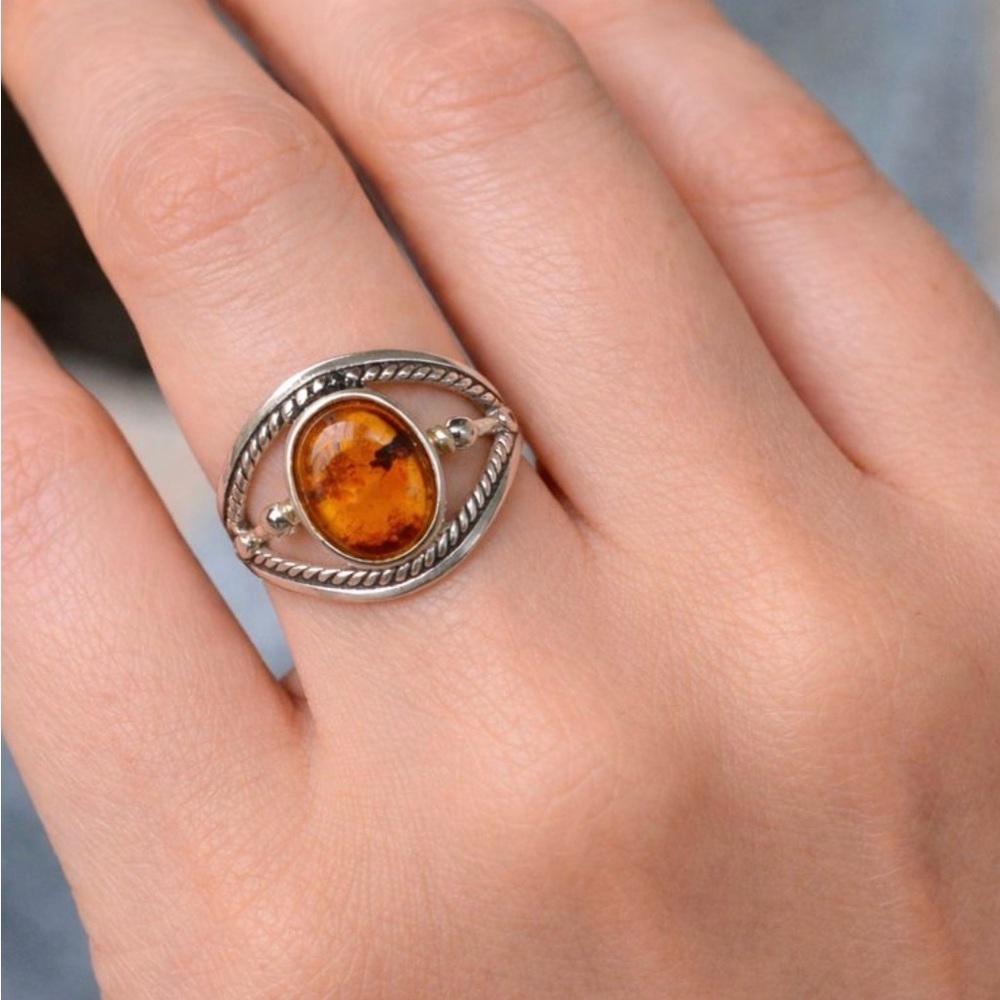 This is a vintage sterling silver .925 ring with an oval amber stone. Size 7